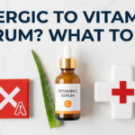Vitamin C serum with allergy warning and first-aid cross props beside aloe leaf on white surface