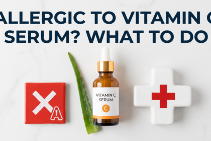 Vitamin C serum with allergy warning and first-aid cross props beside aloe leaf on white surface