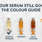Four glass vials showing vitamin C oxidation colour spectrum from clear to brown on white marble