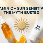 Vitamin C serum and sunscreen tube with sun disc prop on white marble in warm golden tones