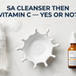 Salicylic acid cleanser and vitamin C serum with tick prop on white stone surface