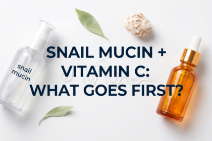 Snail mucin gel and vitamin C serum bottles with shell and leaf on white surface