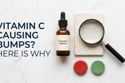 Vitamin C serum bottle with bump texture and magnifying glass caution props on white stone
