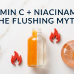 Vitamin C and niacinamide serums with chemistry flask and flame props on white marble