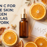 Premium amber serum with gold cap, orange slices and botanical props on champagne marble