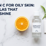 Clear lightweight water-based vitamin C serum bottle with citrus slice, water droplets and oil-free tile on white marble surface for oily skin article